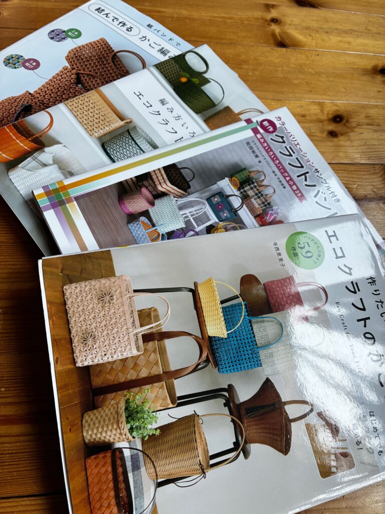 A collection of Japanese craft books focused on making woven bags using paper bands. The covers feature colorful handmade bags displayed in various styles.